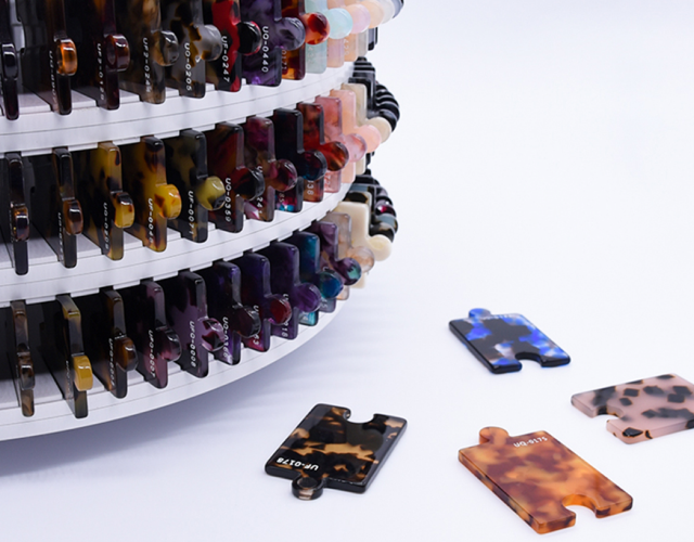 Raw Materials: A close-up view of clear, biodegradable cellulose acetate pellets, the raw material derived from nature used in crafting eco-friendly eyeglass frames.